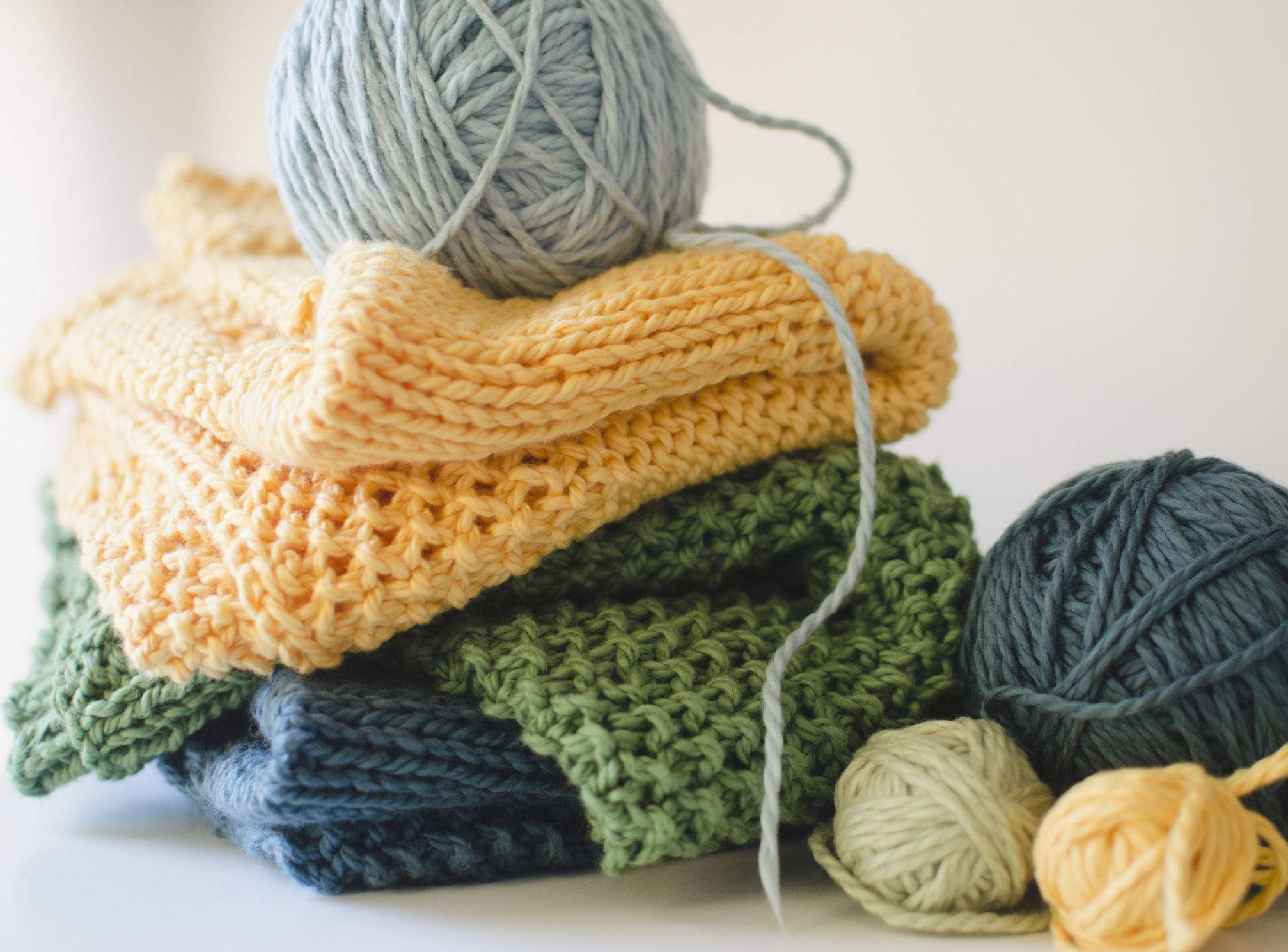 Image of piled knitting projects and yarn.