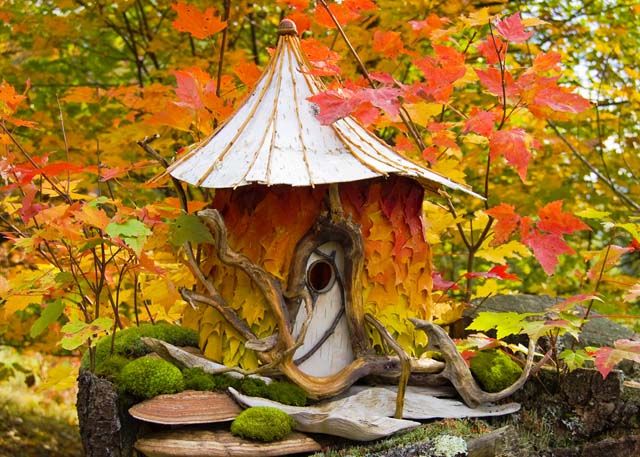 Image of a minature "fairy house" made from natural materials including autumn leaves and twigs.