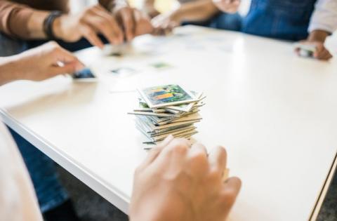 Image of people play a board game together.