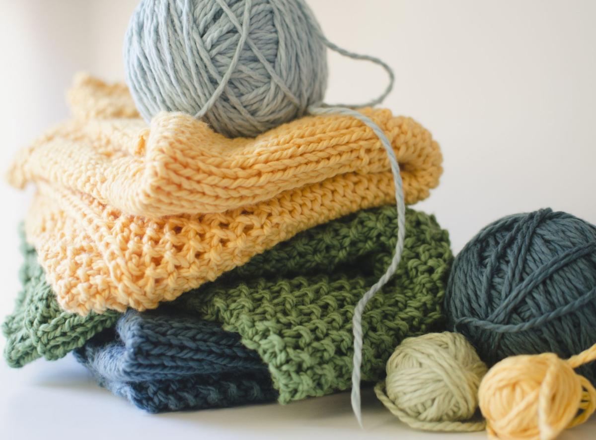 Image of piled knitting projects and yarn.