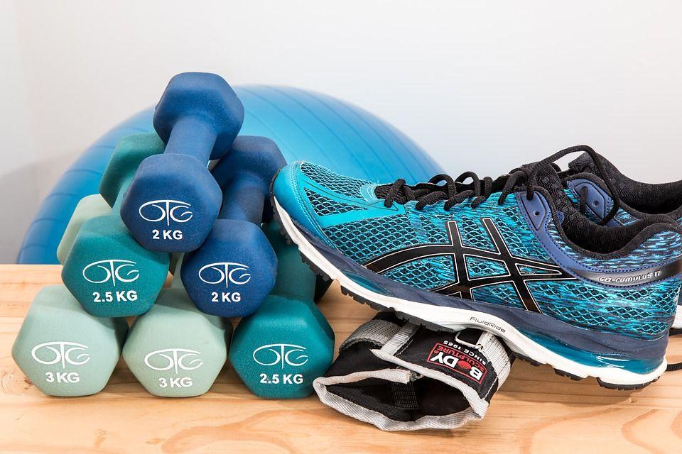 Image of workout shoes and lifting weights.